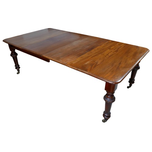 406 - A 19th century mahogany extending dining table, with two additional leaves, turned legs with relief ... 