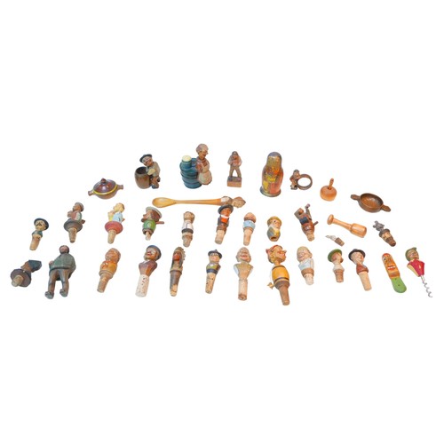 76 - A collection of continental wooden bottle stoppers and treen, including grotesque figures. (1 bag)