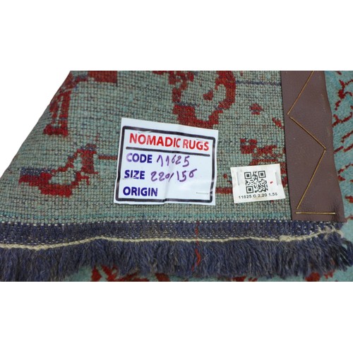 414 - A Shiraz rug, on teal ground with burnt orange decoration, 220 by 115cm.