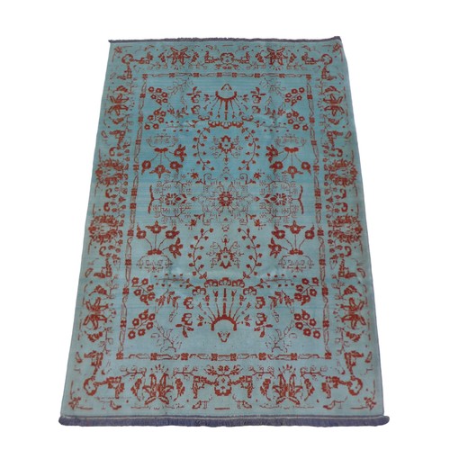 414 - A Shiraz rug, on teal ground with burnt orange decoration, 220 by 115cm.