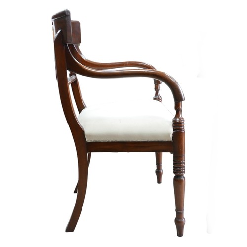 379A - A pair of mahogany Regency style carvers, with upholstered seats, raised upon turned legs. (2)