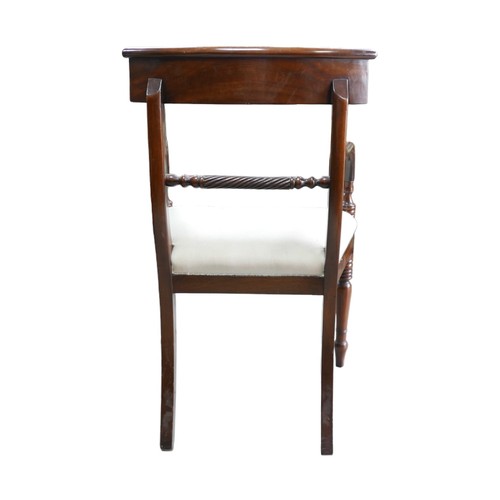 379A - A pair of mahogany Regency style carvers, with upholstered seats, raised upon turned legs. (2)