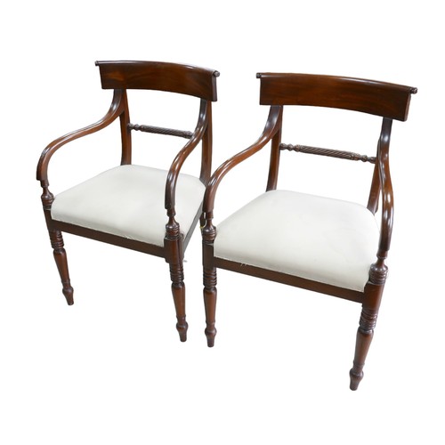 379A - A pair of mahogany Regency style carvers, with upholstered seats, raised upon turned legs. (2)