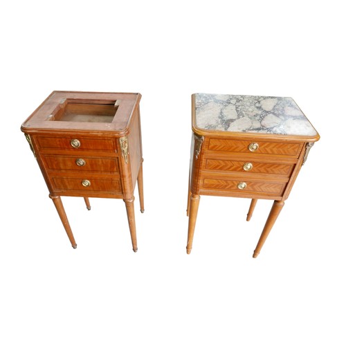 387A - A pair of Empire style bedside cabinets, with gilt metal mounts, raised upon tapered legs, one with ... 