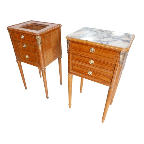 387A - A pair of Empire style bedside cabinets, with gilt metal mounts, raised upon tapered legs, one with ... 