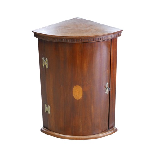 363A - A mahogany bow fronted corner cabinet, with single interior shelf.