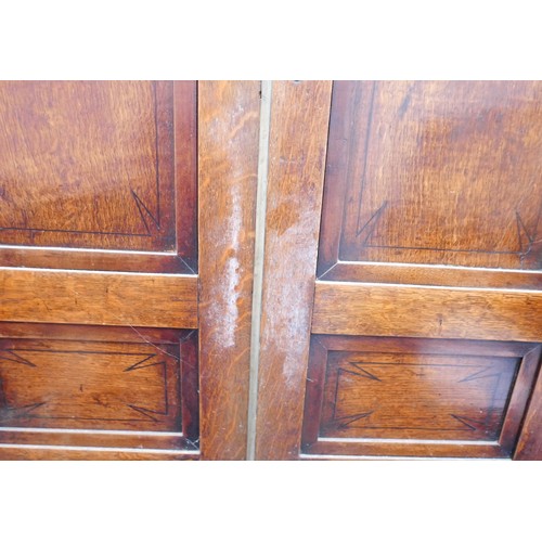 403 - A Georgian oak corner cupboard, in two sections, inlaid ebony detail to the frieze, with brass trim ... 