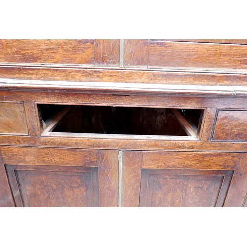 403 - A Georgian oak corner cupboard, in two sections, inlaid ebony detail to the frieze, with brass trim ... 