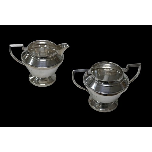 61 - Two pieces of George VI silver tea wares, comprising a milk jug, 13 by 9.5 by 9.5cm high, and a twin... 