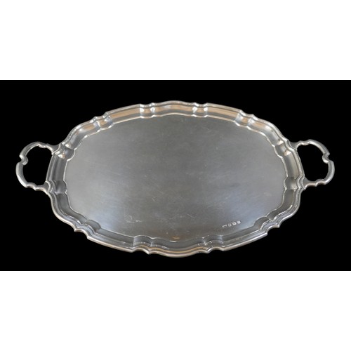 4 - An Elizabeth II silver twin handled tray, with shaped outline, Emile Viner, Sheffield 1956, 56 by 35... 