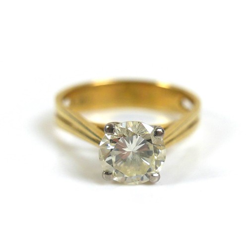 An 18ct gold 1.55ct diamond solitaire ring, the round faceted cut stone, 7.6 by 4.5mm, in four claw white gold setting to a yellow gold tapering shank with pierced sides, stamped '18ct', size Q/R, 5.3g.