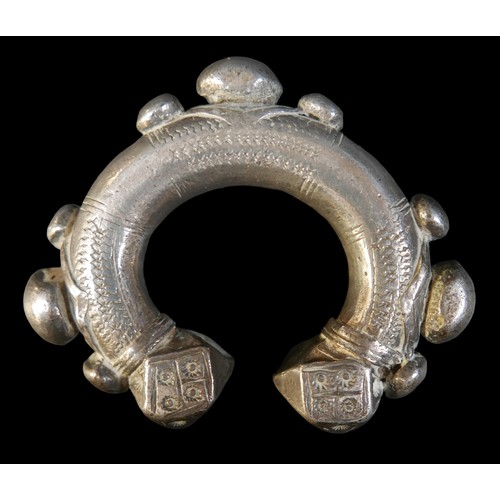 224 - Two Persian metal 'anklets', with stamped and applied decoration, larger anklet measured 9.5cm acros... 