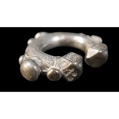 224 - Two Persian metal 'anklets', with stamped and applied decoration, larger anklet measured 9.5cm acros... 