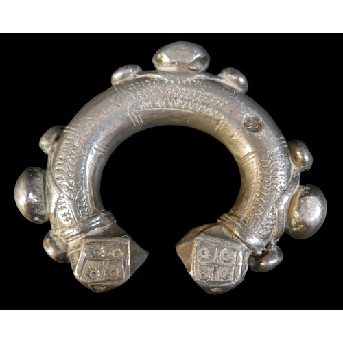 224 - Two Persian metal 'anklets', with stamped and applied decoration, larger anklet measured 9.5cm acros... 