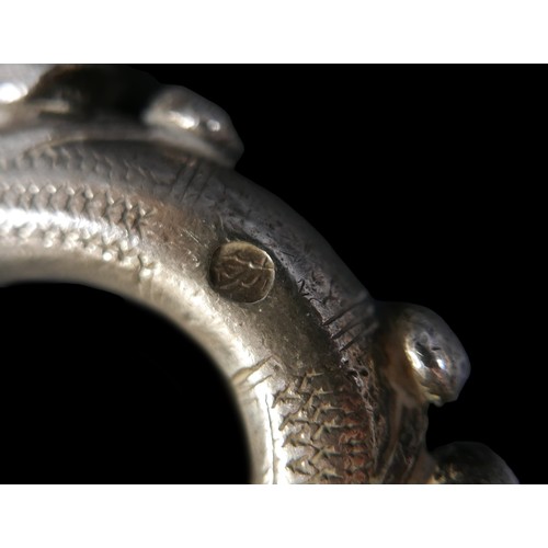 224 - Two Persian metal 'anklets', with stamped and applied decoration, larger anklet measured 9.5cm acros... 