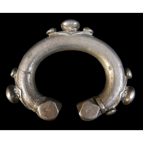 224 - Two Persian metal 'anklets', with stamped and applied decoration, larger anklet measured 9.5cm acros... 