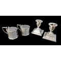 Four pieces of Edwardian silver, comprising a pair of mustard pots with hinge lids, without glass li... 