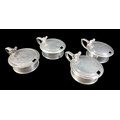 Four William IV and later matched silver mustard pots, including one William IV example, rubbed armo... 