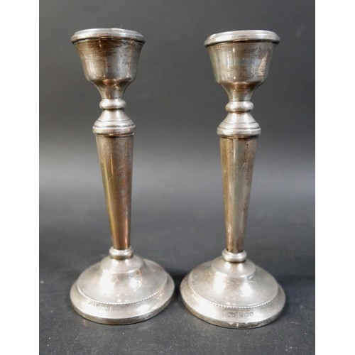 50 - A small collection of silver items, comprising two pairs of silver weighted vases, 16cm high, a sing... 