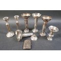 A small collection of silver items, comprising two pairs of silver weighted vases, 16cm high, a sing... 