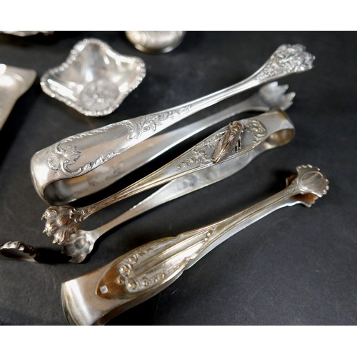 13 - A collection of fourteen pieces of white metal/plated items, including seven sugar nips. (1 bag)