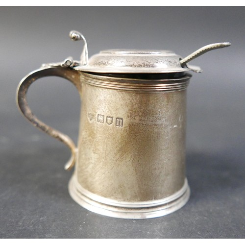 62 - A group of four silver items, comprising a milk jug, a sugar bowl, a tankard mustard with plated spo... 