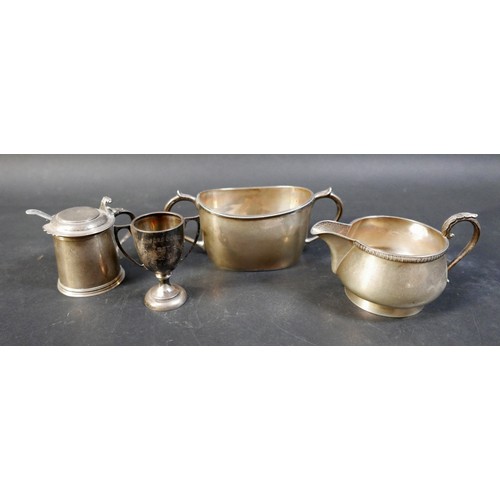 62 - A group of four silver items, comprising a milk jug, a sugar bowl, a tankard mustard with plated spo... 