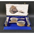 An Edwardian silver backed dressing table hair brush set, with hand mirror, 27cm, two hair brushes w... 