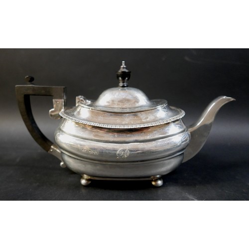 71 - A George V silver teapot, with ebony finial and handle, 30 by 11.5 by 16.5cm high, a twin handled su... 