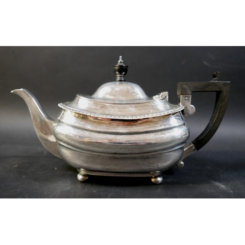 71 - A George V silver teapot, with ebony finial and handle, 30 by 11.5 by 16.5cm high, a twin handled su... 