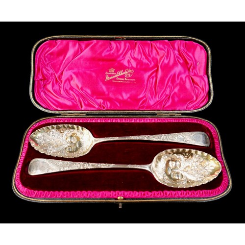 26 - An associated pair of George III silver berry spoons, with blank cartouches, one rubbed maker's mark... 