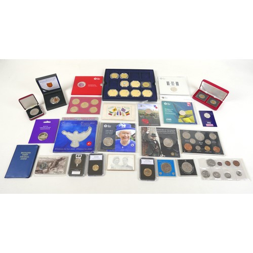 82 - A collection of mint coins and sets, mostly cased and relating to WWII and Remembrance, including 20... 