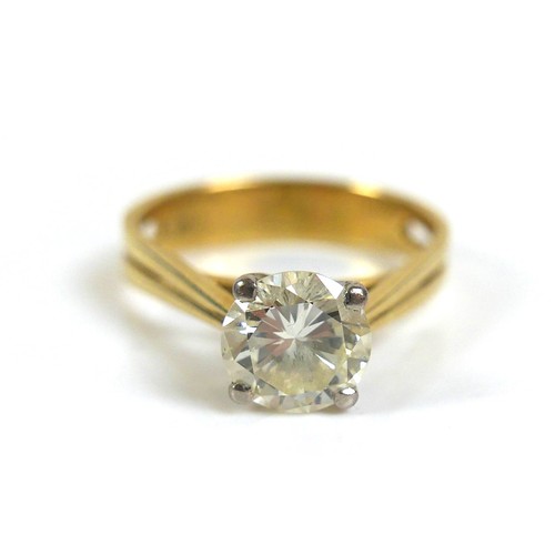 306 - An 18ct gold 1.55ct diamond solitaire ring, the round faceted cut stone, 7.6 by 4.5mm, in four claw ... 