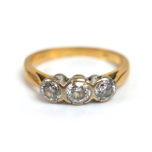 281 - An 18ct three stone diamond ring, central stone approximately 4mm, flanked by 3mm diameter stones, s... 