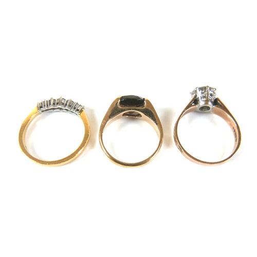 186 - A group of three gold rings, comprising a diamond seven stone ring, size N, a smokey quartz set vint... 