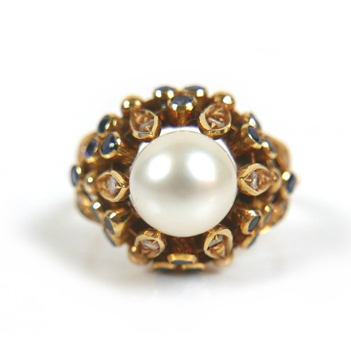 262 - An 18ct yellow gold dress ring, set with centrally with a pearl, 8mm, clasped by six slender leaves ... 