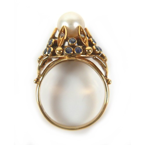 262 - An 18ct yellow gold dress ring, set with centrally with a pearl, 8mm, clasped by six slender leaves ... 