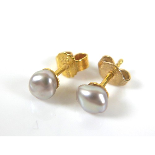 165 - A pair of 14ct gold pearl earrings, 1.0g, together with and a gold citrine set ring tests to approxi... 