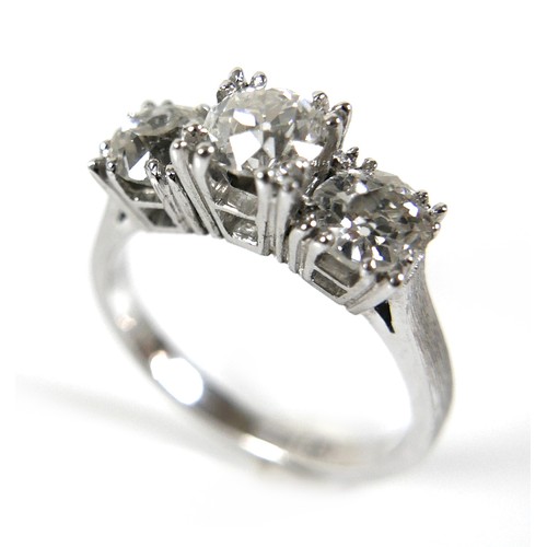 293 - A 14ct white gold three stone diamond ring, the central stone approximately 0.50ct, flanked by sligh... 