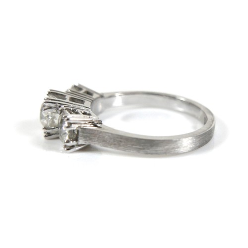 293 - A 14ct white gold three stone diamond ring, the central stone approximately 0.50ct, flanked by sligh... 