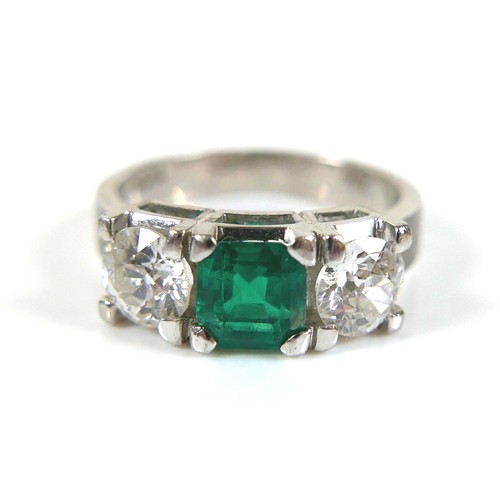 304 - A 14ct white gold diamond and emerald type three stone ring, each diamond approximately 0.48ct, 4.5g... 