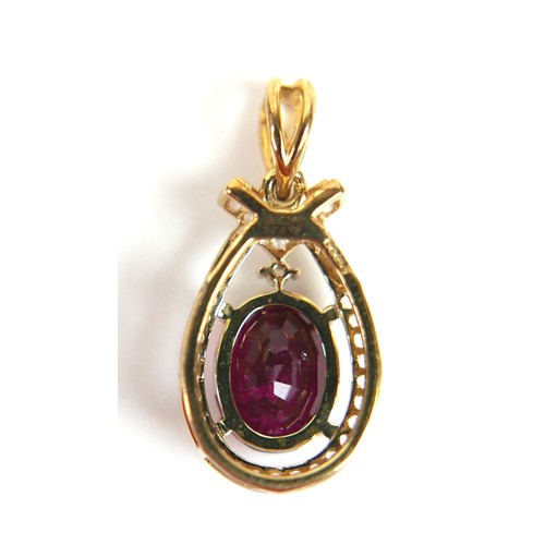 176 - A 9ct gold red tourmaline and white zircon oval form pendant, the tourmaline approximately 7 by 9mm,... 