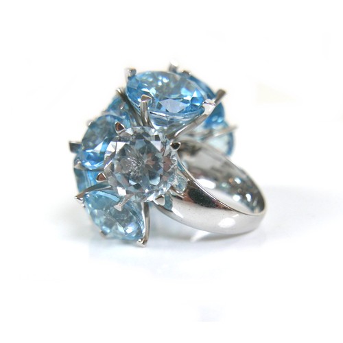 298 - An unusual 18ct white gold dress ring, fitted with twelve brilliant cut blue stones, possibly topaz ... 