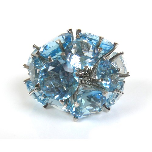 298 - An unusual 18ct white gold dress ring, fitted with twelve brilliant cut blue stones, possibly topaz ... 