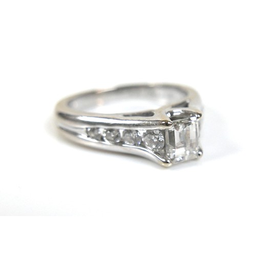 300 - An 18ct white gold and diamond ring, the central stone emerald cut with a convex faceted table, 4.8 ... 