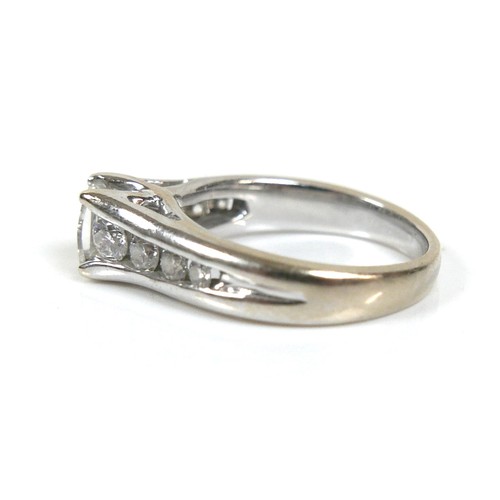 300 - An 18ct white gold and diamond ring, the central stone emerald cut with a convex faceted table, 4.8 ... 