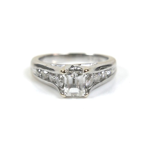 300 - An 18ct white gold and diamond ring, the central stone emerald cut with a convex faceted table, 4.8 ... 