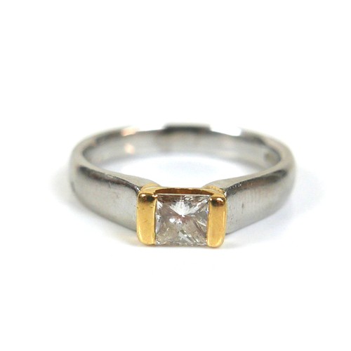 296 - A platinum and diamond solitaire ring, with a rectangular faceted cut stone, 4.1 by 3.9 by 2.1mm, ap... 