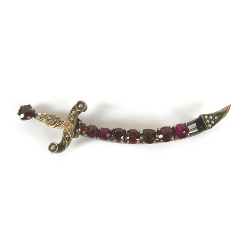 197 - A small group of jewellery, comprising a yellow metal sword shaped brooch, set with red stones and s... 