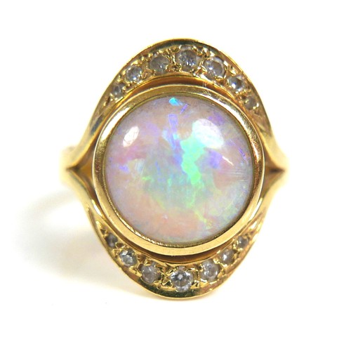 287 - An 18ct gold, opal and diamond ring, centered by a round cabochon opal, 10.5mm, pave set above and b... 